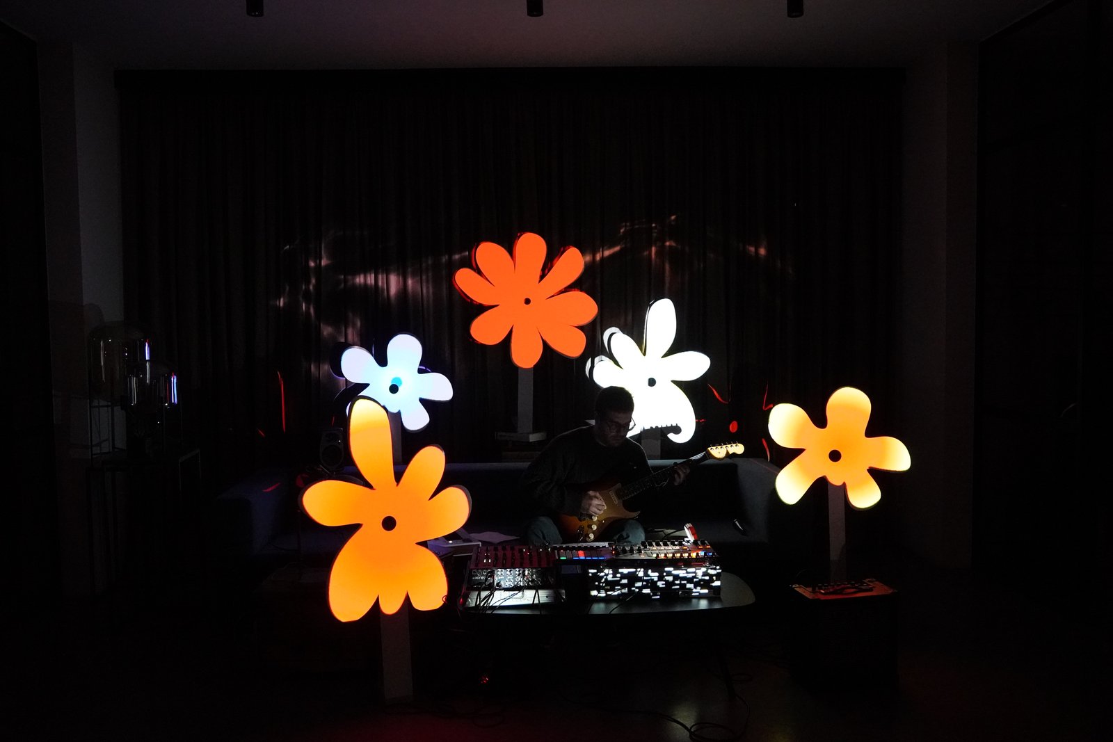 The same set with the flower sculptures lit in warm orange and white