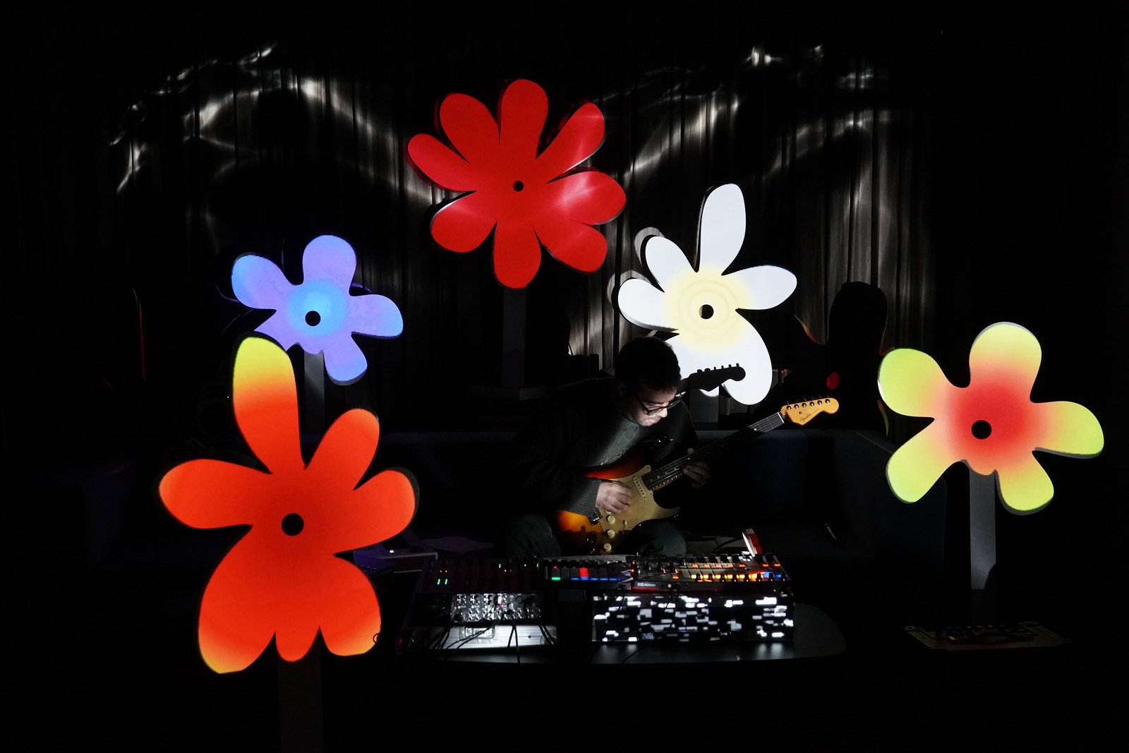 Close view of the red, blue, white and orange flower sculptures around the desk